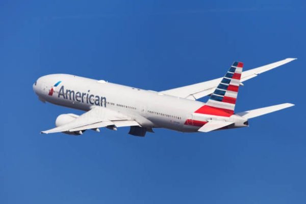 Barcelona, Spain - August 21, 2018: American Airlines Boeing 777-200ER banking left after taking off from El Prat Airport in Barcelona, Spain.