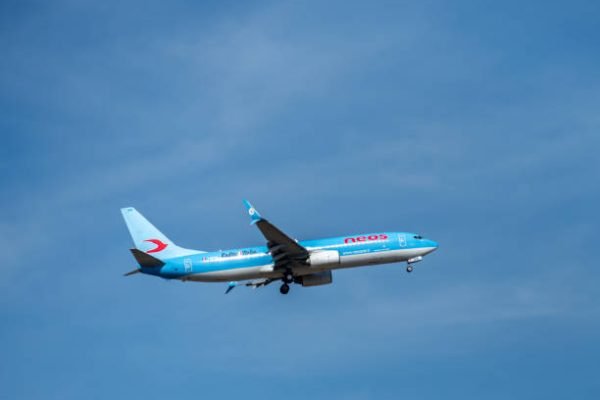 Rome, Italy - August 17, 2019: Airplane from Neos flying in the blue sky. Neos S.p.A. is an Italian leisure airline with its headquarters in Somma Lombardo and main base at Milan-Malpensa Airport