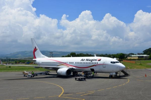 Honiara, Guadalcanal Island, Solomon Islands: Air Niugini Boeing 737-86Q NG Next Generation (registration P2-PXC, MSN 30290) at Honiara International Airport - Air Niugini is the national airline of Papua New Guinea based in Port Moresby and based at Port Moresby Airport. Starboard view, unloading bags.