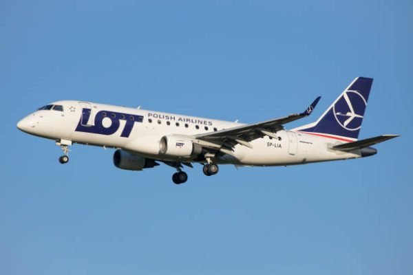 Vienna, Austria - 30 April, 2023: LOT Polish Airlines landing with Embraer 170 airplane in Vienna with clear blue sky