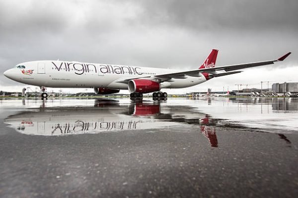ZArich, Switzerland - April 27, 2013: Airbus A330-300 of Virgin Atlantic Airways in brilliant lighting conditions shortly after a rain shower with reflections on the ramp at Zurich airport.